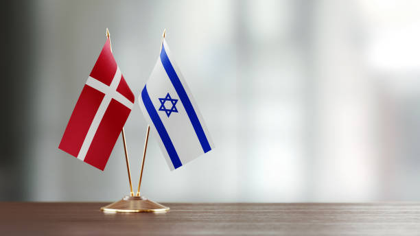 istock Danish And Israeli Flag Pair On A Desk Over Defocused Background 925033230