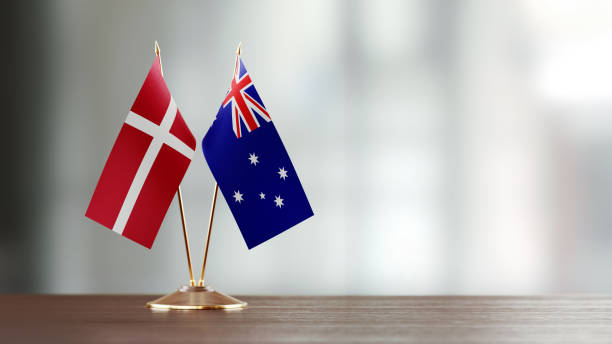 istock Danish And Australian Flag Pair On A Desk Over Defocused Background 925037074