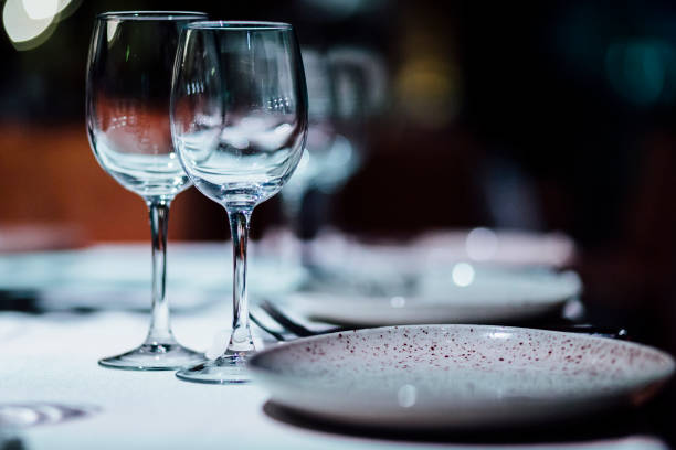 Luxury table settings for fine dining with and glassware, beautiful blurred  background. For events, weddings.