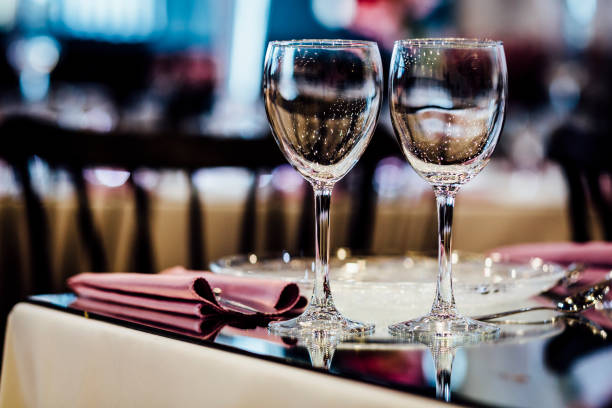 Luxury table settings for fine dining with and glassware, beautiful blurred  background. For events, weddings.