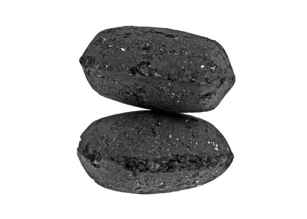 istock Charcoal briquettes on white background 925048264