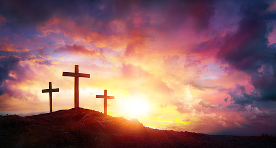 Crucifixión de Jesús Cristo al amanecer - tres cruces en colina photo