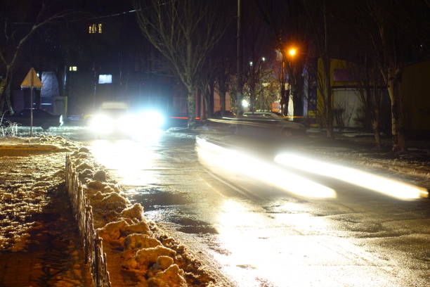 istock Light from car headlights at winter night. 925051586