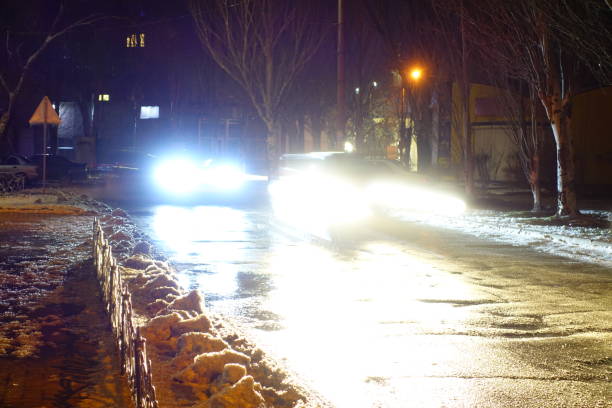 istock Light from car headlights at winter night. 925051596