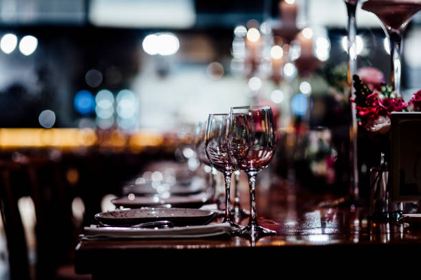 Luxury table settings for fine dining with and glassware, beautiful blurred  background. For events, weddings.