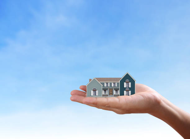 istock Mortgage concept by house from  hand 925052012