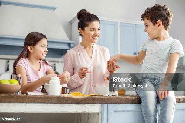 Delighted Mother Having Breakfast With Her Children Stock Photo - Download Image Now