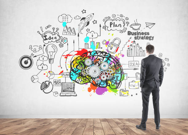 istock Rear view of a businessman looking at cog brain 925057026