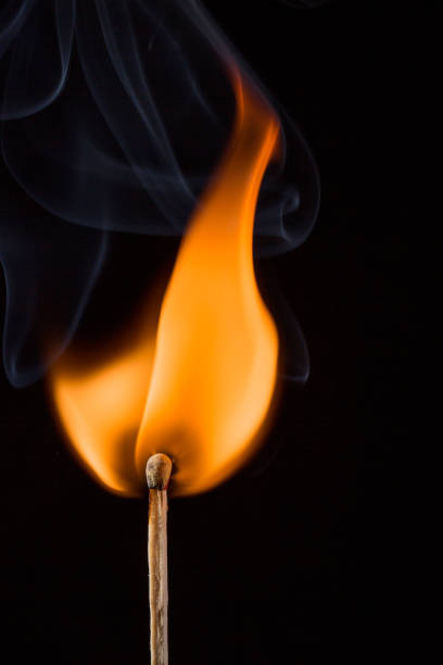 istock Lit wooden match on black background 925060020