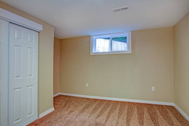Empty room, sand beige walls, carpet floor in a luxury home. stock photo