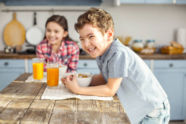 istock Content little boy having breakfast with his sister 925072106