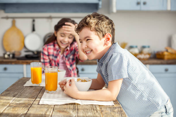 istock Happy little boy having breakfast with his sister 925072170