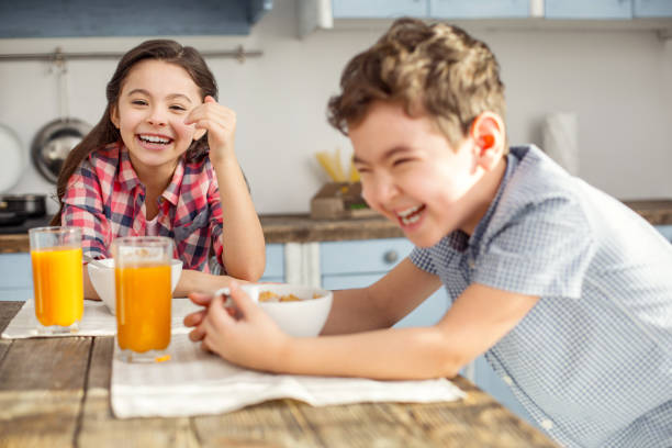 istock Happy little kids laughing at the table 925072342