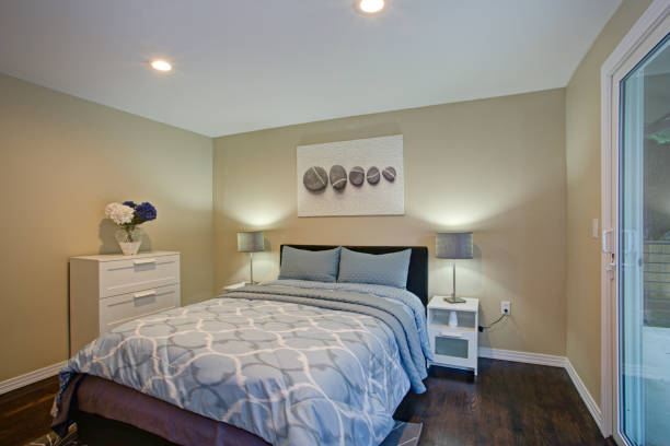 istock Second floor bedroom with taupe walls, blue bed 925075750