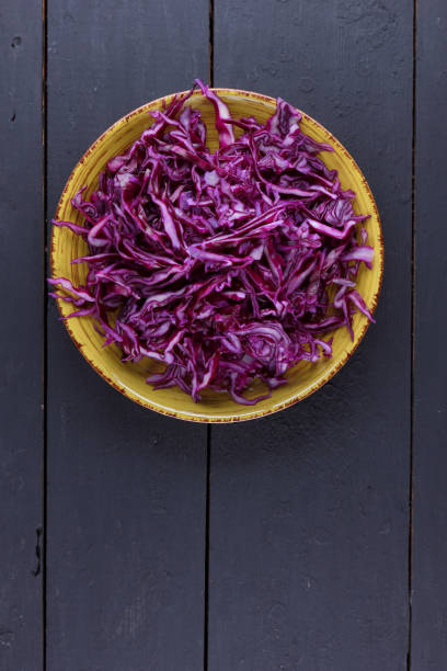 istock Sliced purple cabbage in clay pots, purple cabbage on a dark wooden background, sliced cabbage in the style of minimalism, vegetables in rustic style, vegetarian product, vitamins, healthy food 925076310