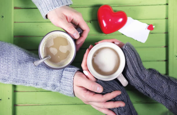 istock Couple drinking hot coffee at wooden table on a date 925076648