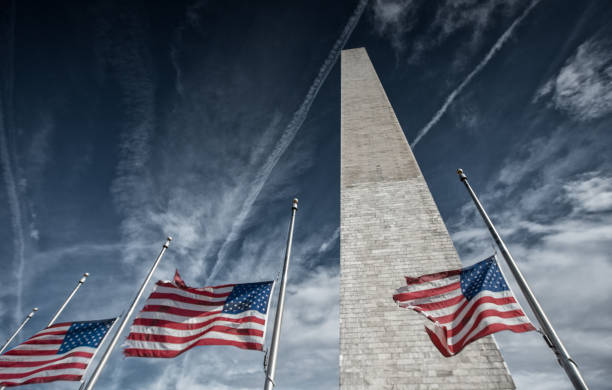 istock Washington Monument with American Flags and Clouds in Washington, DC 925079828
