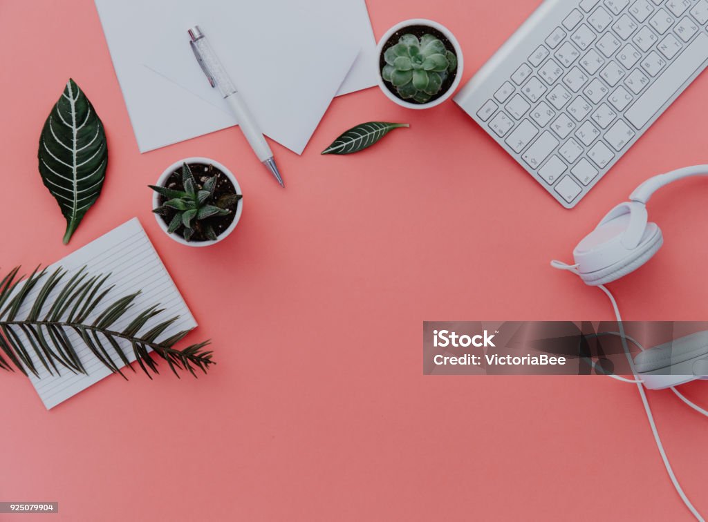 Woman home office desk workspace with laptop, headphones and plants over pastel. Flat lay, top view. stylish female concept. Desk Stock Photo
