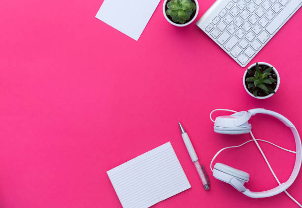 istock Top view of creative woman's desktop, white tablet and headphones with blank copy space screen. Mock up, flat lay, pink pastel background 925079912