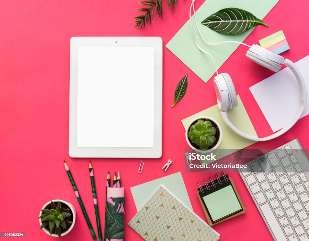 Tablet PC, succulent plants and office supplies over pastel  background. Office table. Flat lay mock up for social media blog Desk Stock Photo
