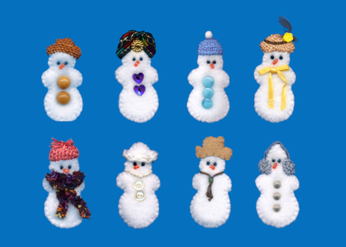 Eight hand stitched fleece snowpeople. Stitched by the photographer.