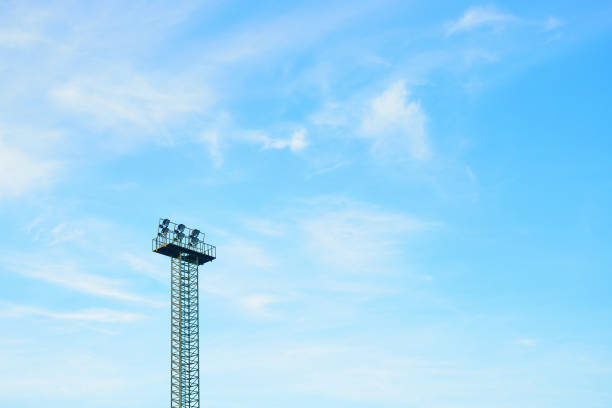 istock Floodlight tower of stadium on blue sky. 925087282