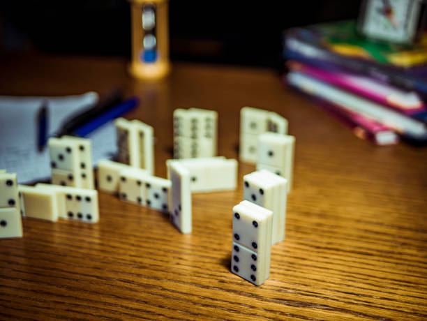 istock domino pieces with books and pens on the table 925091148
