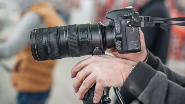 istock Man hand holding camera and take the photo 925091250