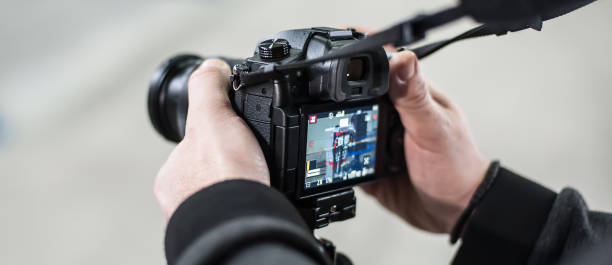 istock Man hand holding camera and take the photo 925091492