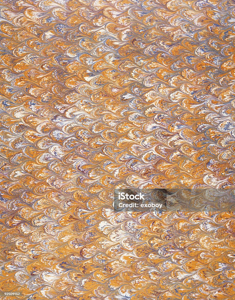 scalloped french marbled paper scalloped french marbled paper with browns, tans, blues, and many other colors swirled in a scalloped pattern 2004 Stock Photo