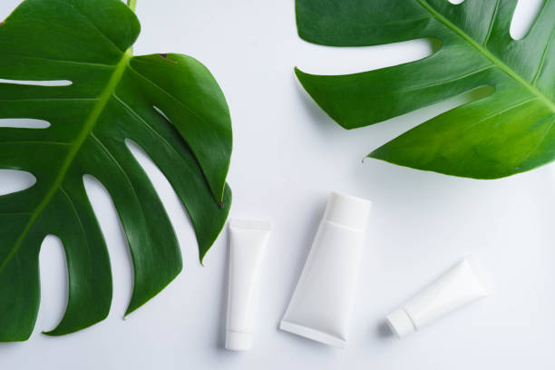 istock Beautiful natural cosmetics and leaves on light background 925092276