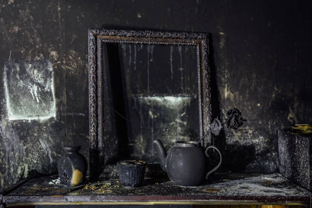 Burnt room interior. Burnt still life. Charred wall, picture frame, pot with burned rose in black soot Burnt room interior. Burnt still life. Charred wall, picture frame, pot with burned rose in black soot. ash photos stock pictures, royalty-free photos & images