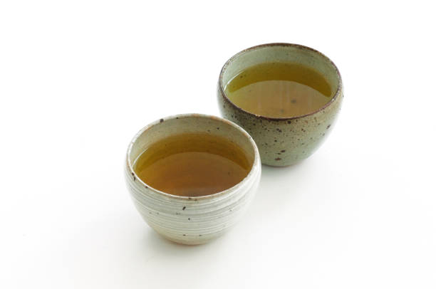 hot green tea in a bowl on a white background