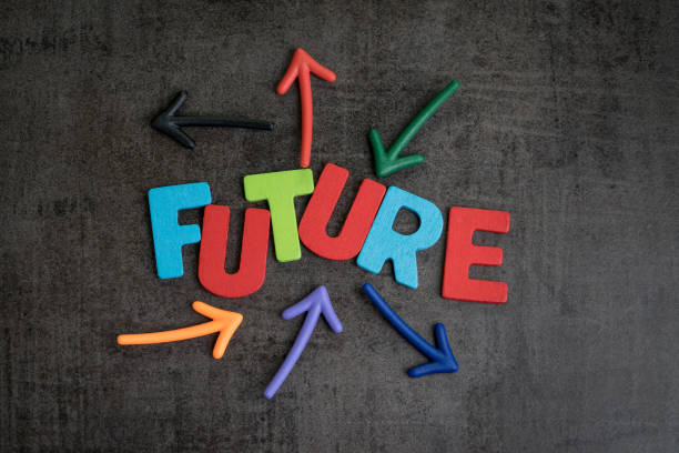 istock Colorful wooden alphabets arrage word FUTURE with multi directional arrow on dark black chalckboard wall, risk or fear for life journey, uncertain future or next business goal concept 925103814