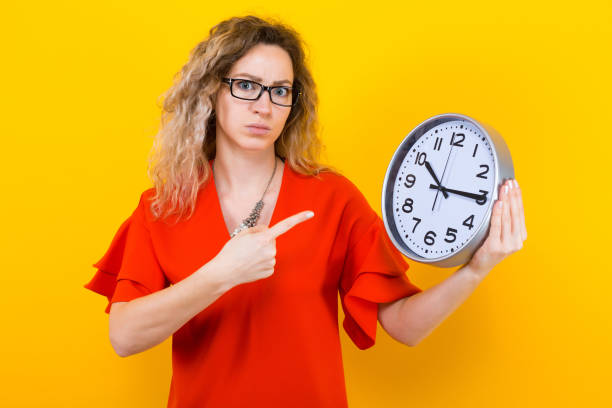 istock Woman in dress with clocks 925104414