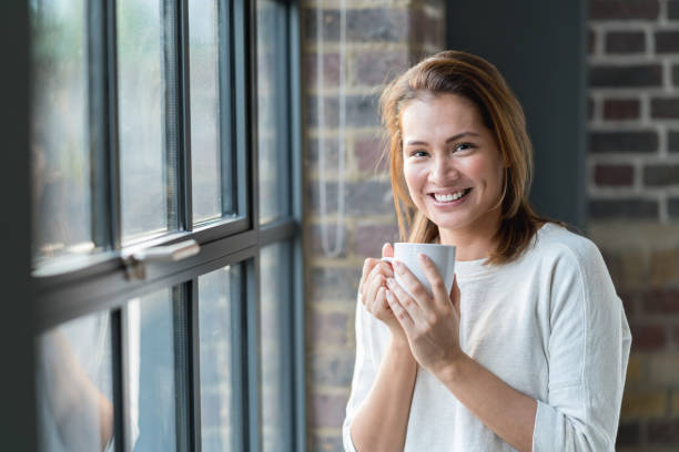 istock Happy woman at home drinking coffee 925104544