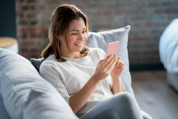 istock Woman at home using app on her cell phone 925104608