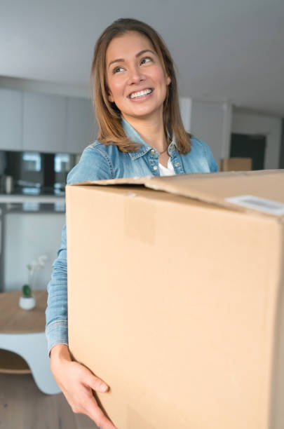 istock Woman looking happy while moving house 925104646