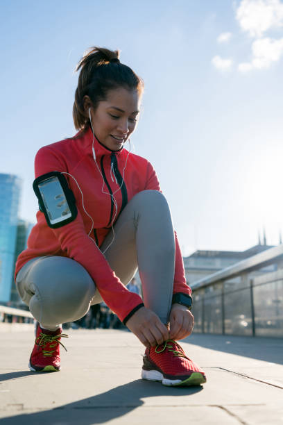 istock Athletic woman tying her shoelace before running 925104680