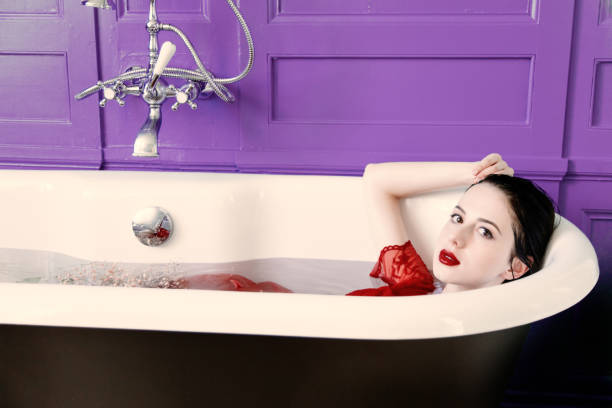 istock young woman in bath with flowers 925104738
