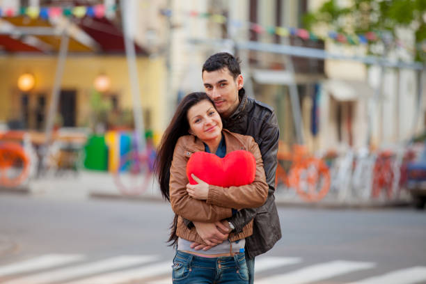 istock Young couple hugging on the streen on the first date. 925104762