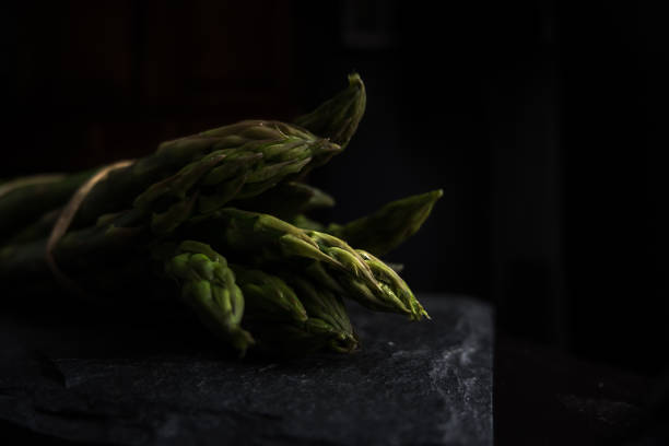 Macro on green asparagus heads selective light