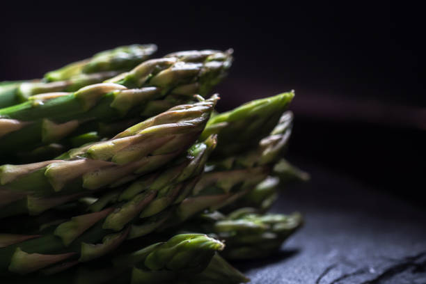 Dark light on a bunch of green asparagus