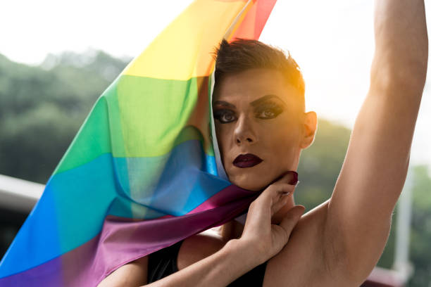 istock Confident Gay Boy Holding Rainbow Flag 925108018