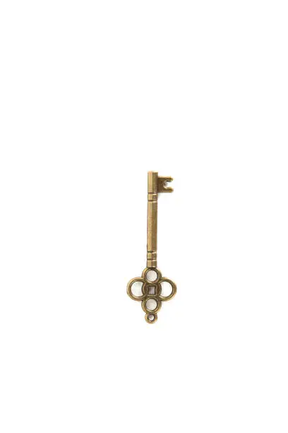 Image of an antique key from brass, isolated on white background