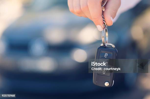Female Car Salesperson Handing Over The New Car Keys Stock Photo - Download Image Now