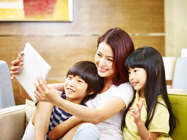 istock asian mother taking a selfie with two children 925122132
