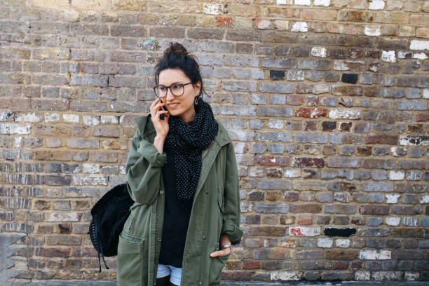 istock Young brunette talking on the cellphone in London downtown 925122402