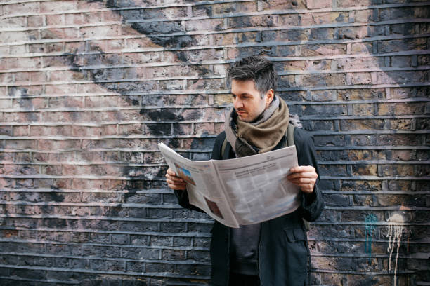 istock Young man reading newspapers on the break 925122906