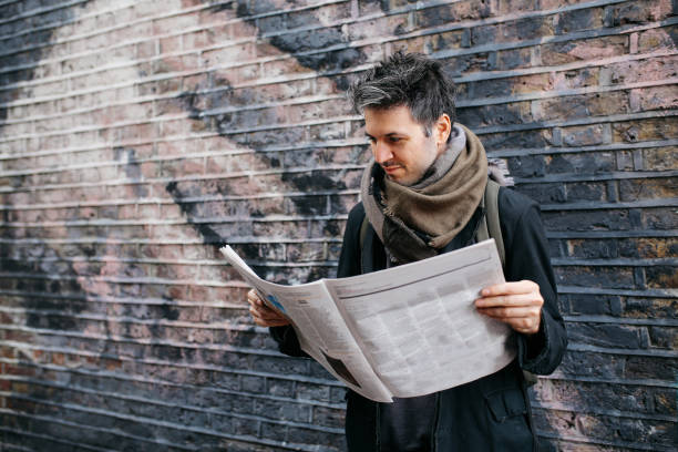 istock Young man reading newspapers on the break 925122940
